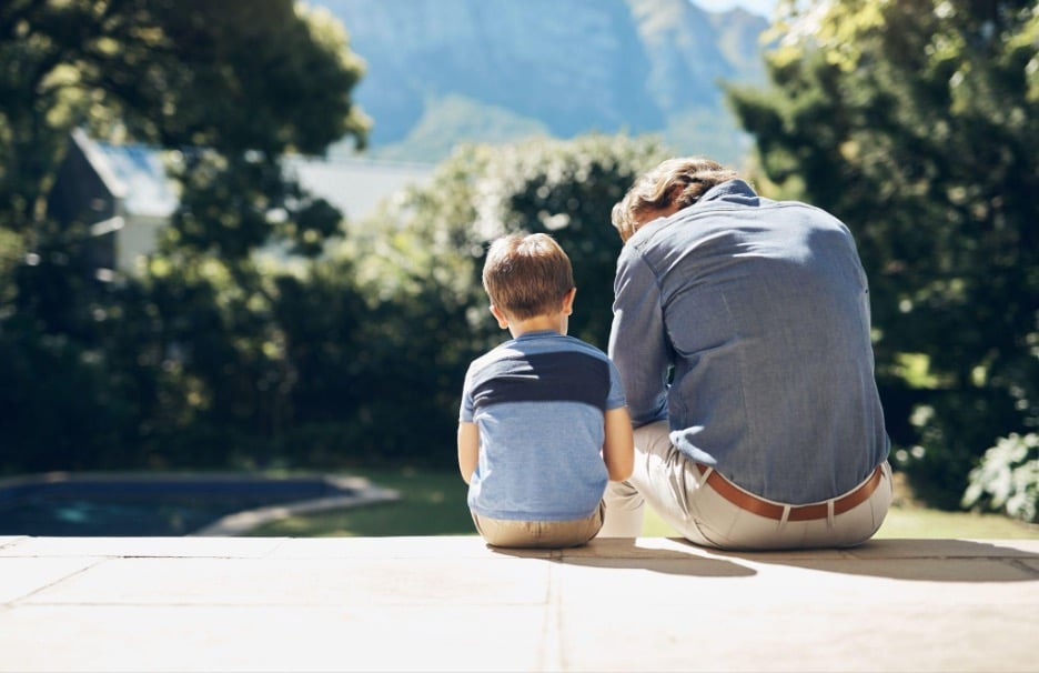 Parent comforting a young child while talking about the loss of a loved one, offering emotional support and guidance through grief – Hospice Care Options.